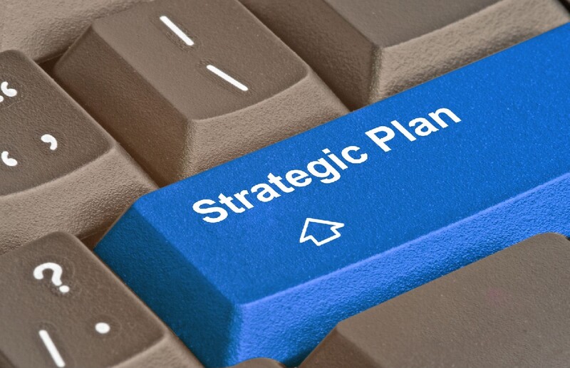 The lower righthand corner of a keyboard with a single blue key imprinted with "Strategic Plan." Stock Photo