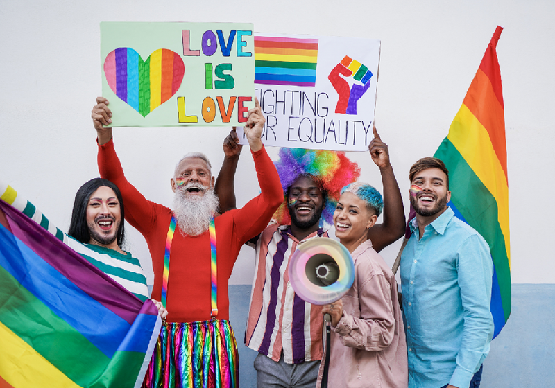 A multiracial group of people dressed for a Gay Pride celebration. Stock Photo