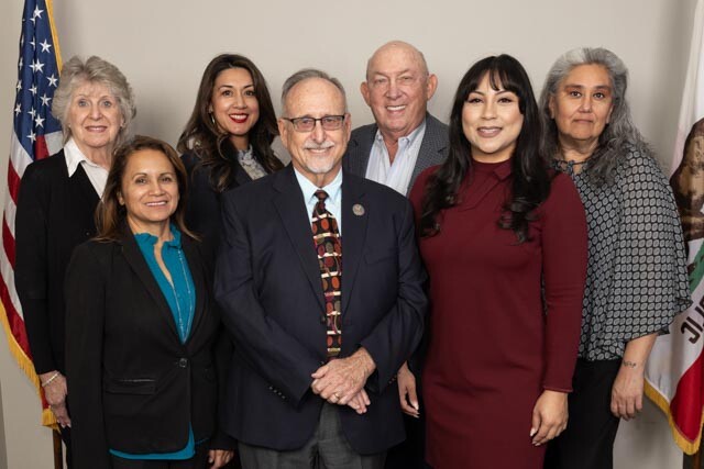 Two rows of the seven Desert Healthcare District and Foundation Board Directors standing and facing the camera. Photo by Lani Garfield