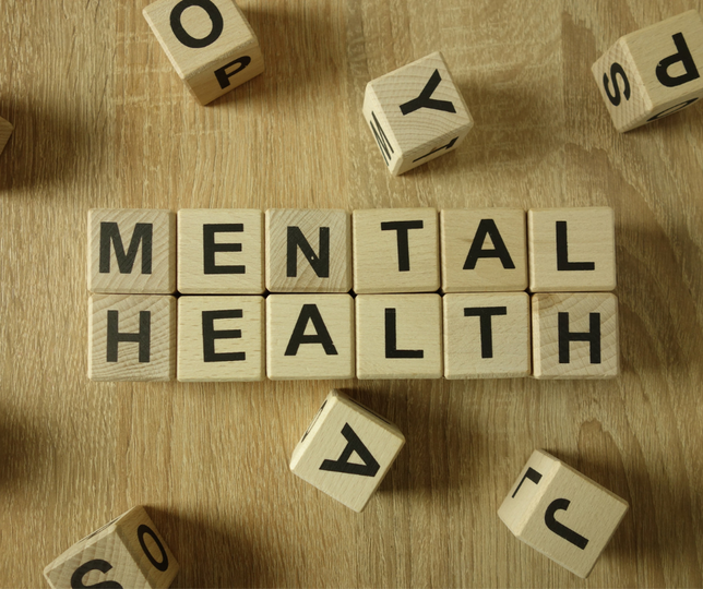 Black letters on blocks spell out in two rows, "Mental Health." Stock Photo